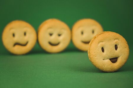 smiling cookies and different emotions on a green background.の写真素材