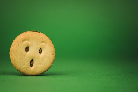 smiling cookies and different emotions on a green background.の写真素材