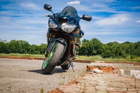 sport bike black with green rims front view.