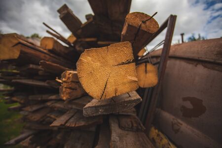 firewood lying in the middle of the hut and one log rests on the chamber