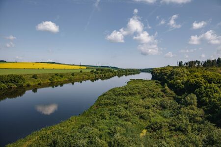 Sunny summer landscape with river.Green hills,fields and meadows Sunrise.Quiet morning.Calm.Warm...