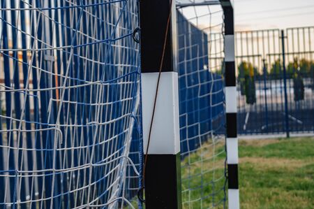 Soccer field with green grass yard and football goal in school area. beautiful sport playground.の写真素材