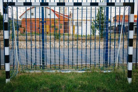 Soccer field with green grass yard and football goal in school area. beautiful sport playground.の写真素材