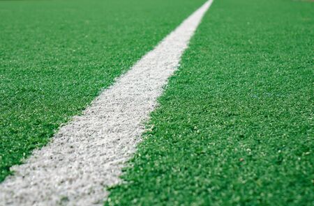 White Stripe Line at The Corner on Artificial Green Soccer Field.