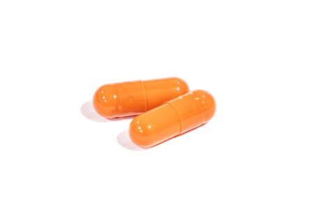 tablets orange, isolated on a white background. medicineの写真素材