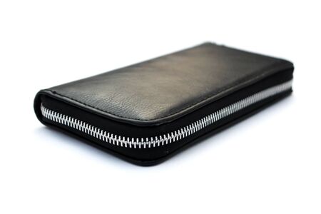 Black leather wallet with dollars isolated on white backgroundの写真素材