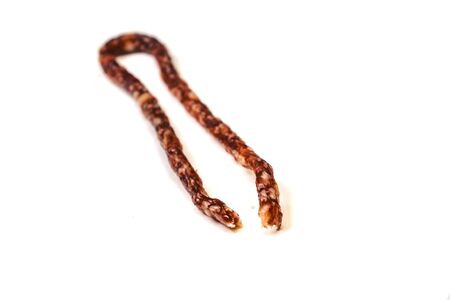 Small smoked sausage with spice isolated on white background.の写真素材