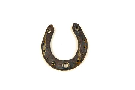Old rusty horseshoe on a white backgroundの写真素材