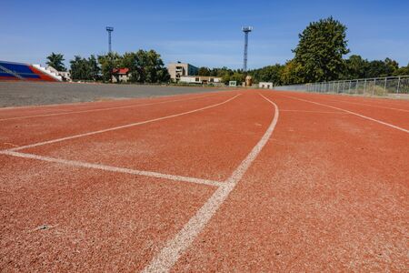 red running track on the athletic stadium. close up.の写真素材