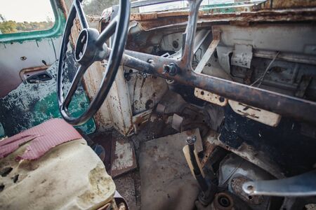 horizontal image of the inside of the front of a very old broken down bus.の写真素材