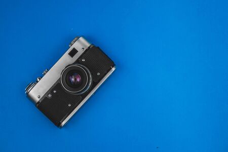 old vintage camera isolated on blue backgroundの写真素材