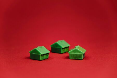 three green houses isolated on red background