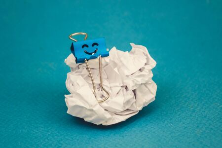 a piece of crumpled brown paper on a blue backgroundの写真素材