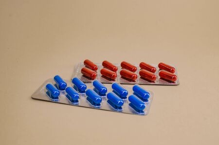 two packs of red and blue pills.の写真素材