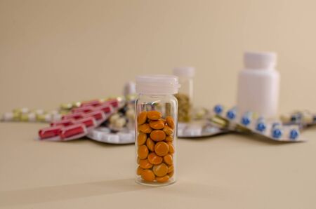yellow tablets in a glass flask are separate from all tablets..