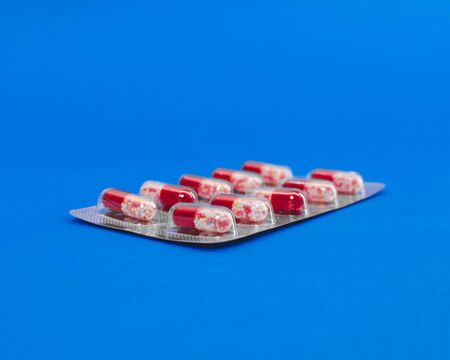 capsule tablets in a package on a blue background..の写真素材