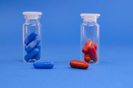 packing red and blue tablets on a blue backgroundの写真素材