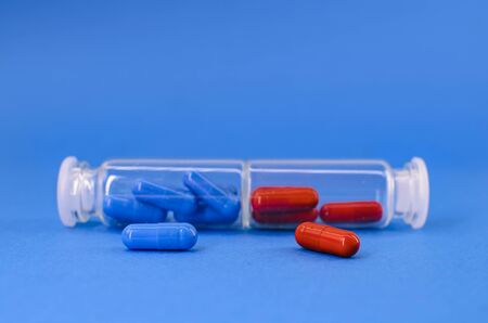 two vessels with red and blue tablets on a blue background.の写真素材