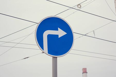 blue road sign, turn right.