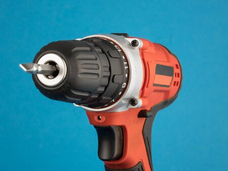 red electric drill on a blue background.の写真素材