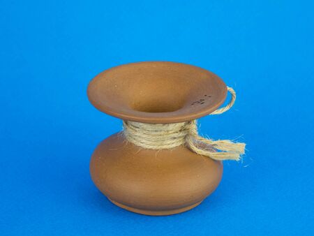 brown jug standing on a blue background.の写真素材