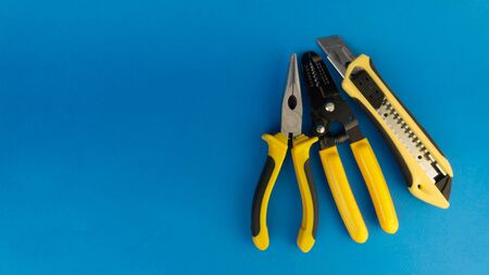a set of yellow construction tools on a blue background.