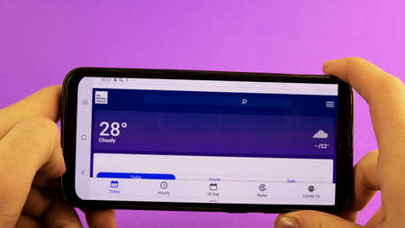 Moscow, Russia - February 22, 2020: the Weather Channel on a person's phoneのeditorial素材