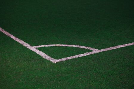 corner of the football field with a white corner mark.