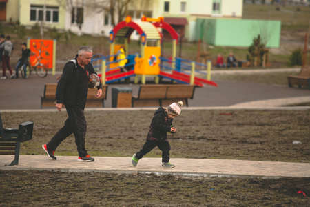 Grandpa and grandson go to play football on the street Moscow Russia April 1 2020.のeditorial素材