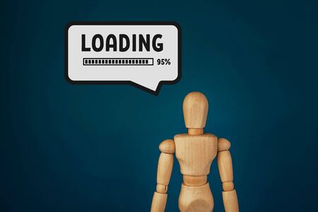 wooden doll is loading on a blue background.