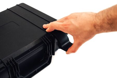 Man's hand opens the case against a white background.