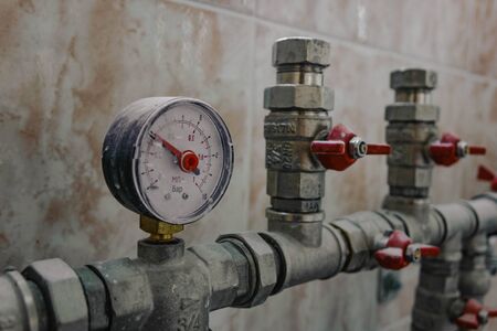 fittings and valve, pipes and adapters. Plumbing fixtures and piping parts. focus on the red crane.の写真素材