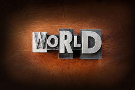 The word world made from vintage lead letterpress type on a leather background.の写真素材