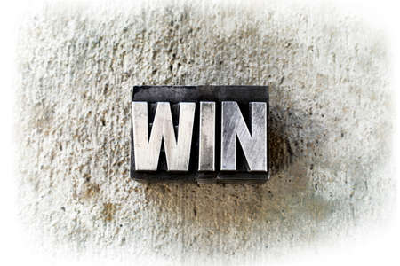The word "WIN" written in old vintage letterpress type.の写真素材