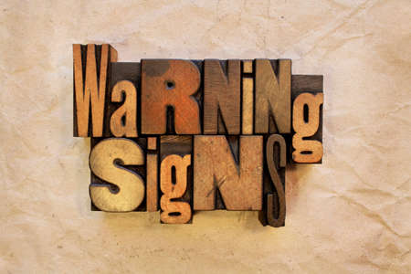 The words Warning Signs written in vintage wood letterpress typeの写真素材