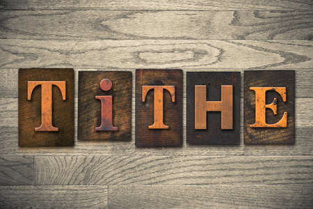 The word "TITHE" written in wooden letterpress type.の写真素材