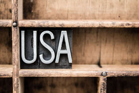 The word USA written in vintage metal letterpress type in a wooden drawer with dividers.
