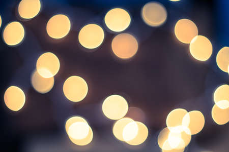 Yellow defocused lights over a soft blue and pink backgroundの写真素材