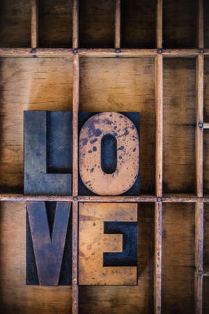 The word love written in vintage wooden letterpress type in a type drawer.の写真素材