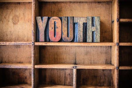 The word YOUTH written in vintage wooden letterpress type in a wooden type drawer.の写真素材