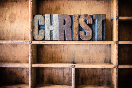 The word CHRIST written in vintage wooden letterpress type in a wooden type drawer.の写真素材