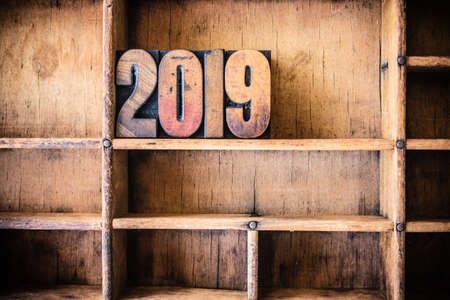 The word 2019 written in vintage wooden letterpress type in a wooden type drawer.の写真素材