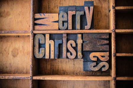 The word MERRY CHRISTMAS written in vintage wooden letterpress type in a wooden type drawer.の写真素材
