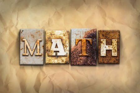 The word "MATH" written in rusty metal letterpress type on a crumbled aged paper background.の写真素材