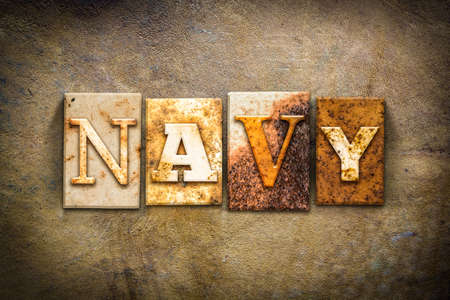 The word "NAVY" written in rusty metal letterpress type on an old aged leather background.の写真素材