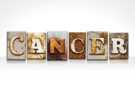 The word "CANCER" written in rusty metal letterpress type isolated on a white background.の写真素材