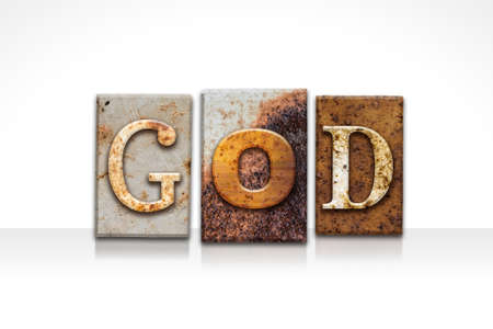 The word "GOD" written in rusty metal letterpress type isolated on a white background.の写真素材