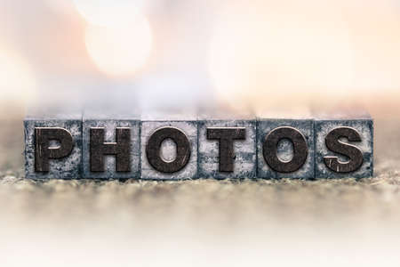 The word "PHOTOS" written in vintage ink stained letterpress type.の写真素材