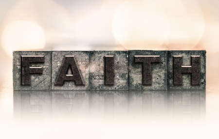 The word "FAITH" written in vintage ink stained letterpress type.の写真素材