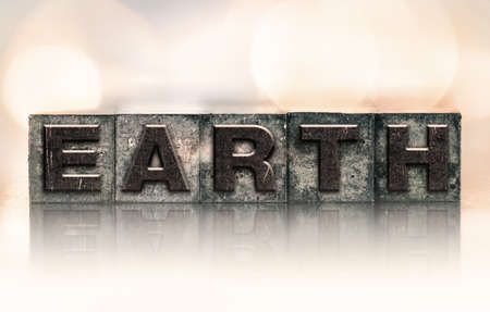 The word "EARTH" written in vintage ink stained letterpress type.の写真素材